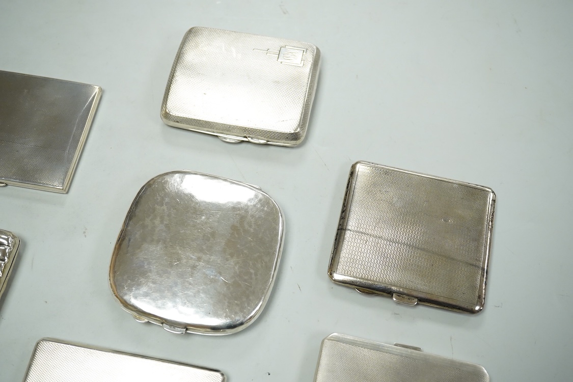 Nine assorted silver cigarette cases, including an Edwardian ribbed case and an engine turned rectangular case by Garrard & Co, Birmingham, 1960, 12.7cm, 32.1oz and one other unmarked white metal cigarette case.
